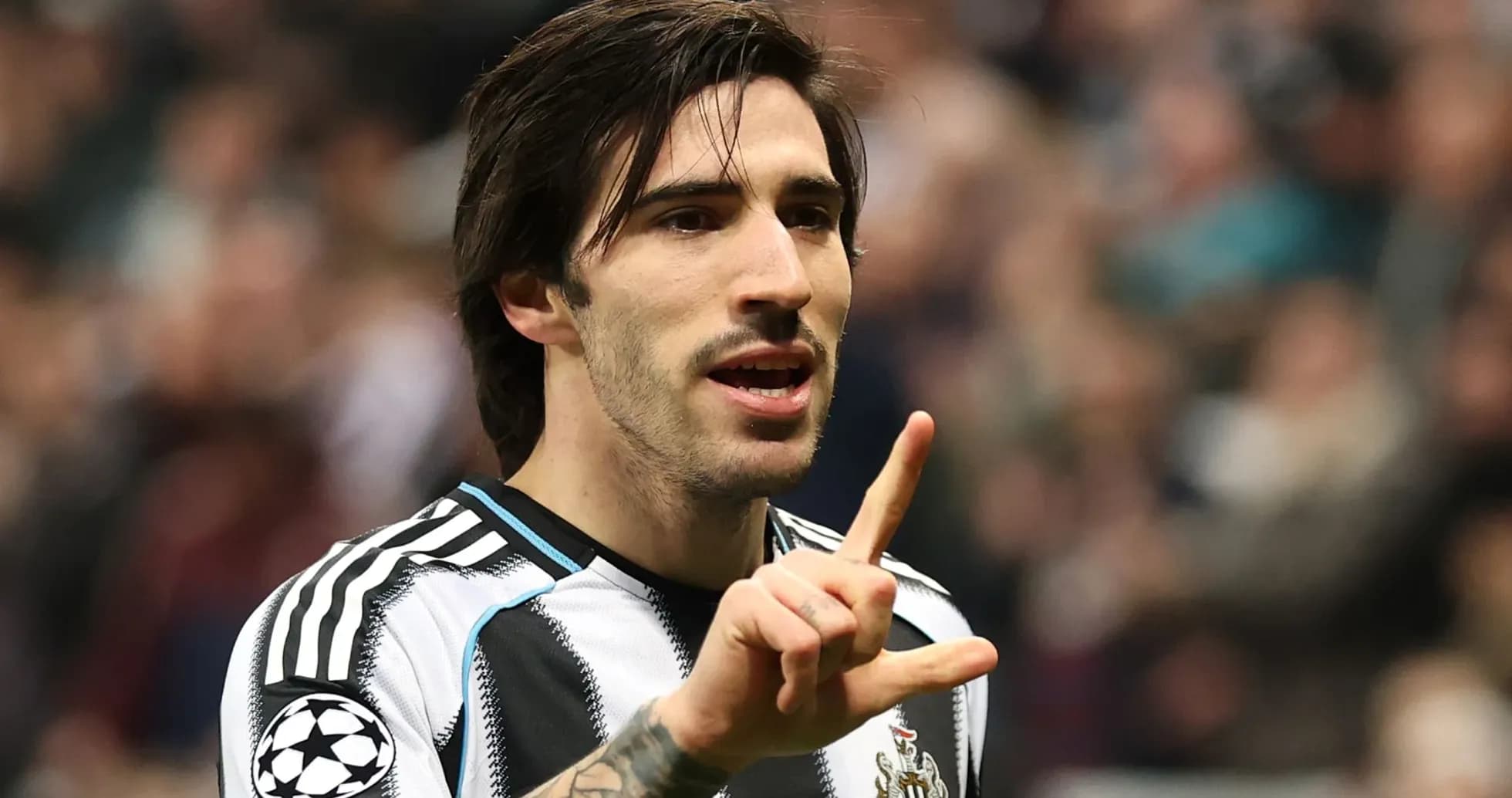 Player gesturing during match with fans in background Player gesturing during match with fans in background