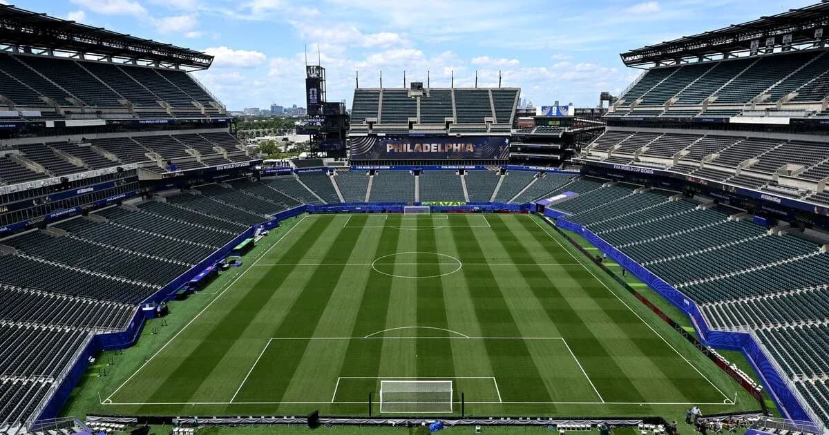 Empty stadium with soccer field and seating areas Empty stadium with soccer field and seating areas