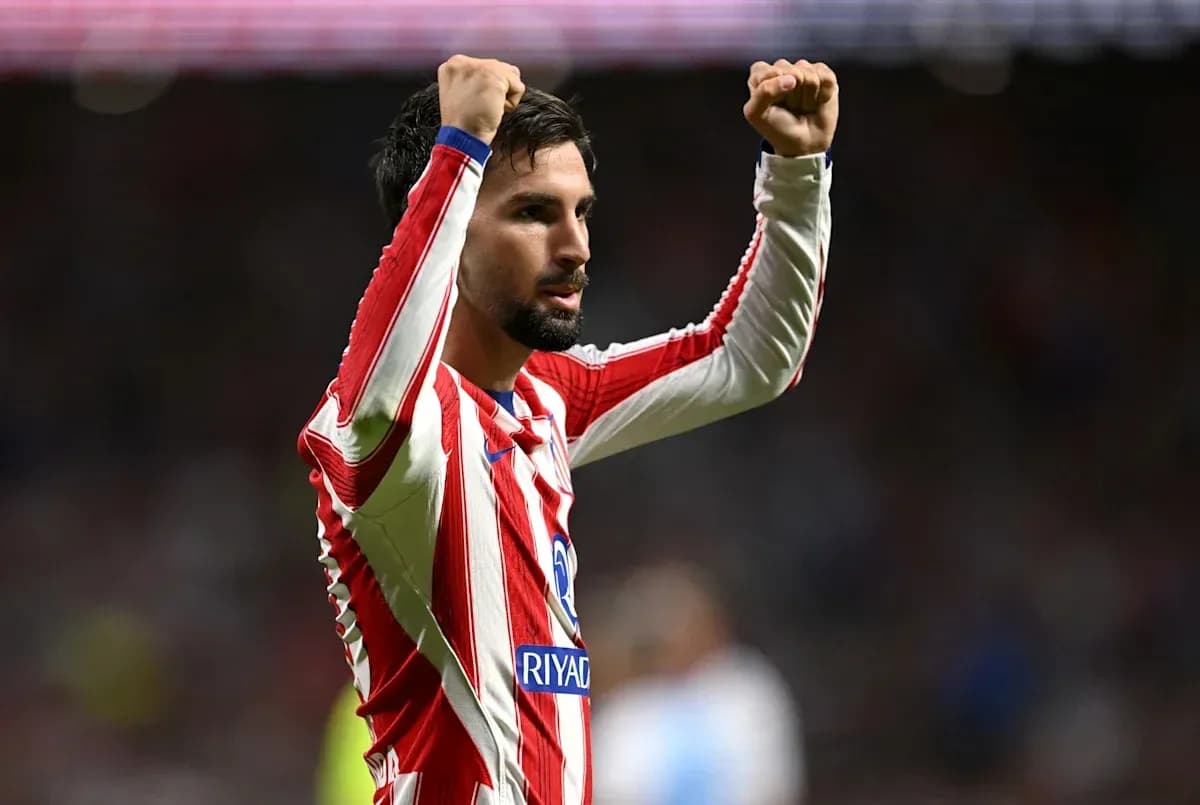 Player celebrating with raised arms on the field Player celebrating with raised arms on the field