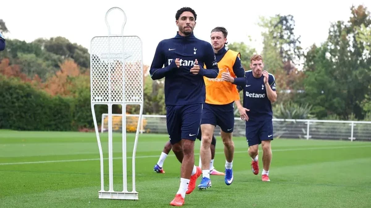 Tottenham players training on pitch with cones Tottenham players training on pitch with cones