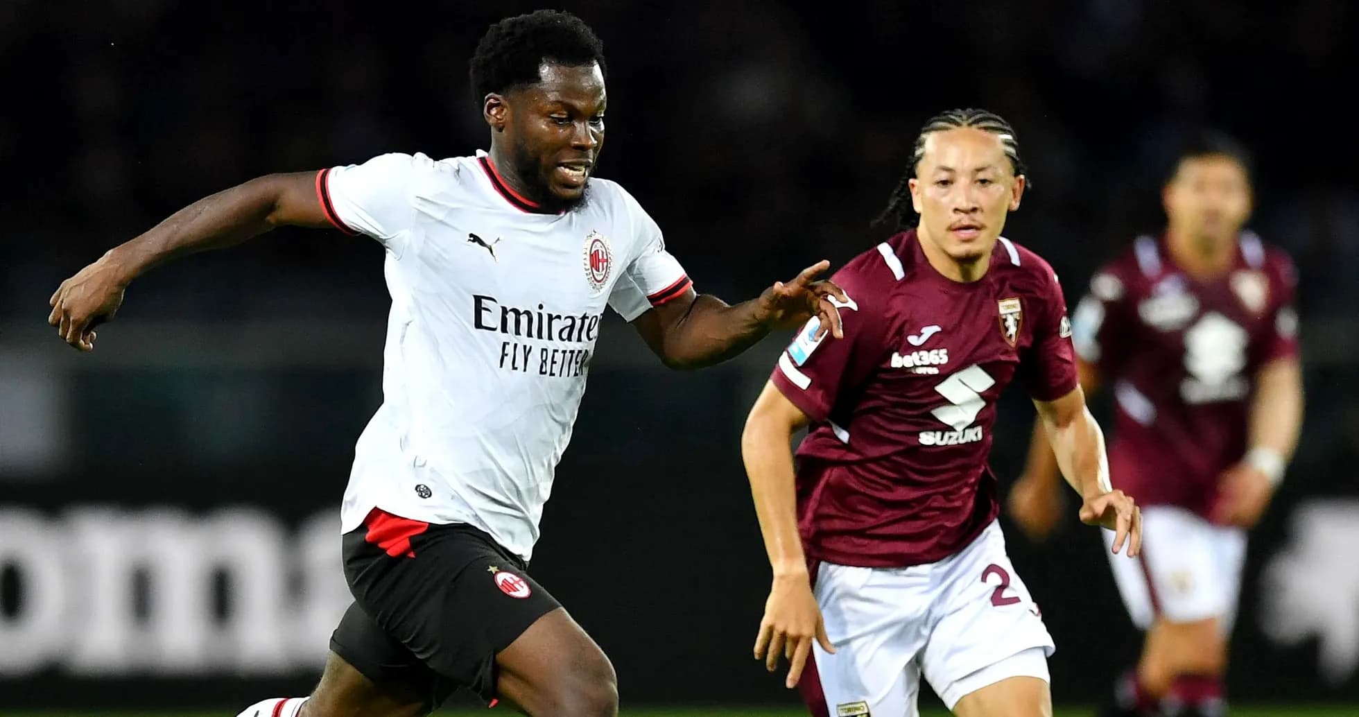AC Milan player running past Torino defender AC Milan player running past Torino defender