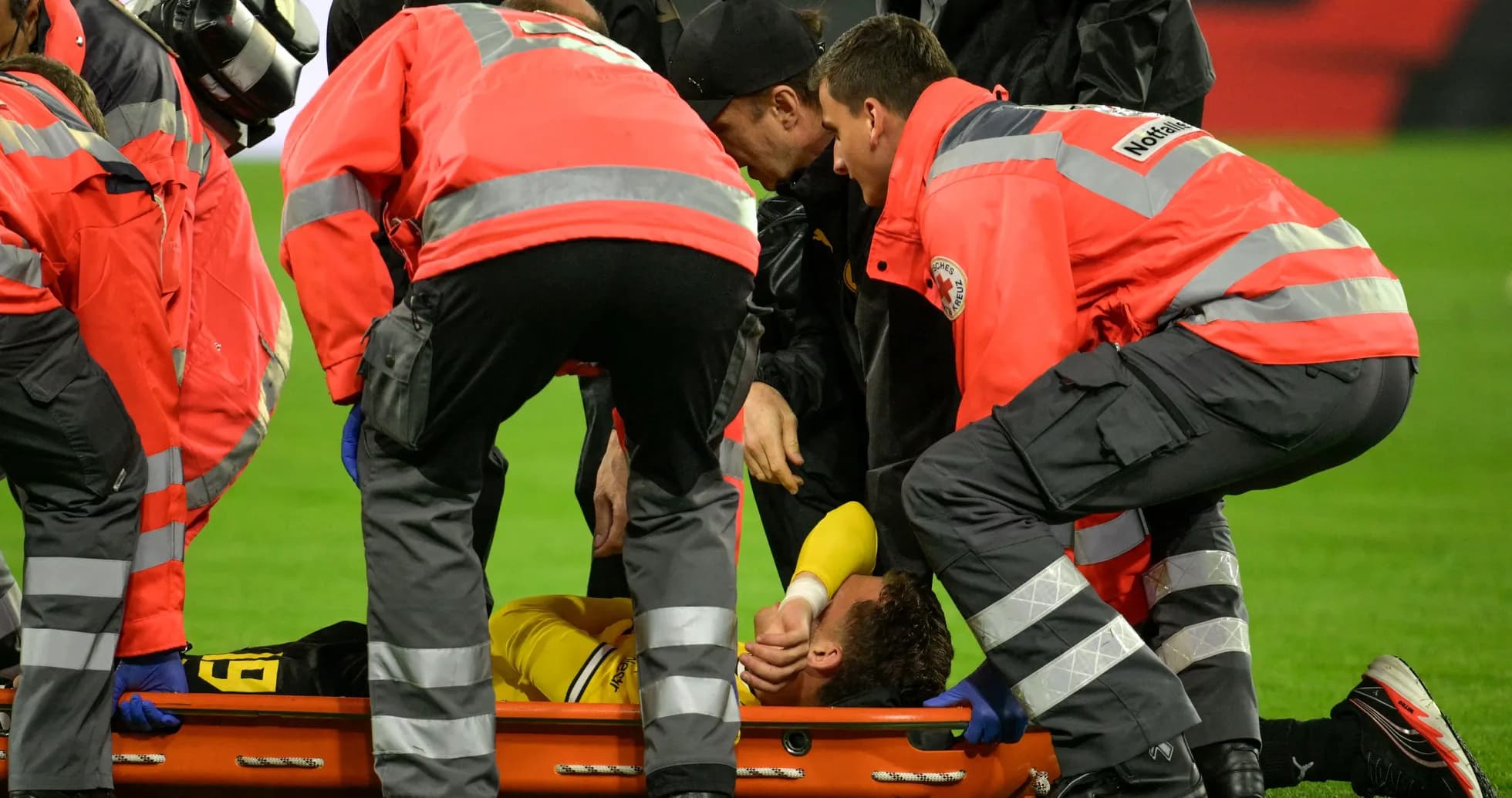 Medical team attending to injured player on stretcher Medical team attending to injured player on stretcher
