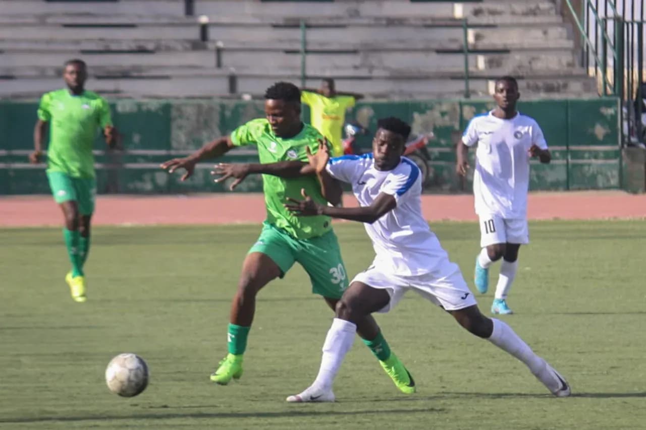 Nasarawa United player tackling Enyimba opponent Nasarawa United player tackling Enyimba opponent