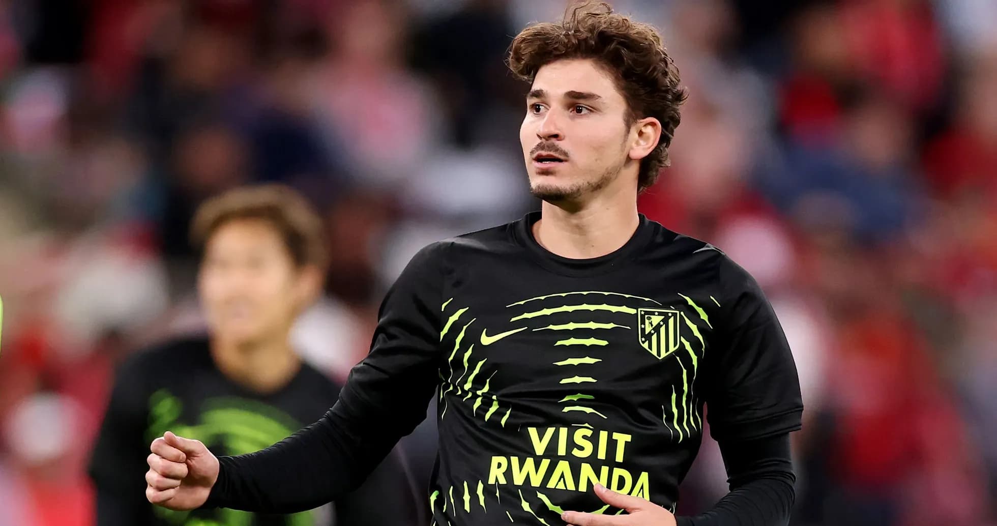 Player warming up in Atletico Madrid training shirt Player warming up in Atletico Madrid training shirt