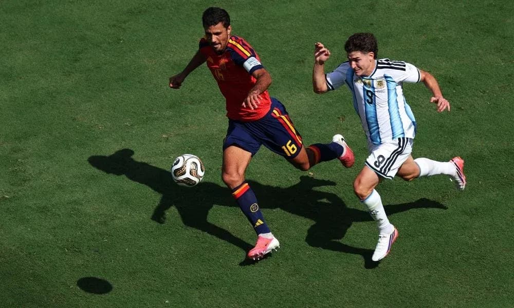 Two players chasing the ball during a match Two players chasing the ball during a match
