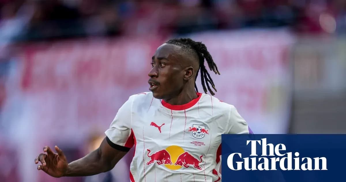 Player in RB Leipzig kit running on the field Player in RB Leipzig kit running on the field