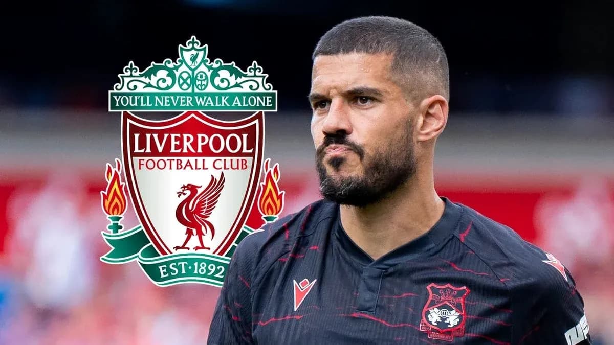 Player in black kit with Liverpool FC logo Player in black kit with Liverpool FC logo