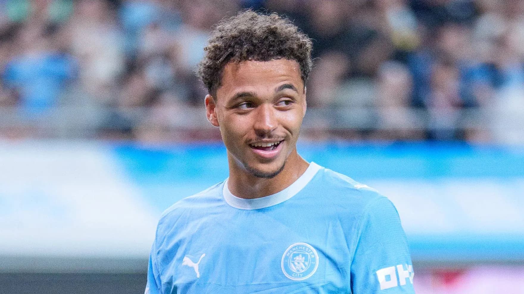 Player smiling during training session in light blue kit Player smiling during training session in light blue kit