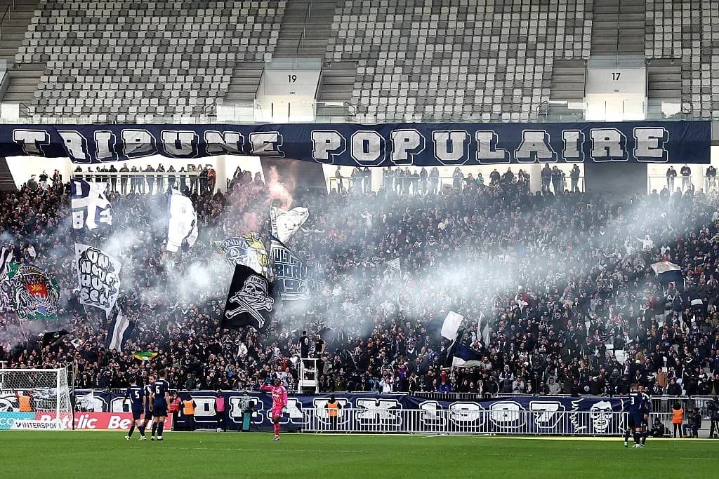 Crowd celebrating with flags and smoke in stadium Crowd celebrating with flags and smoke in stadium