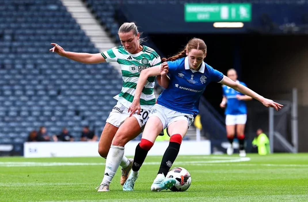 Celtic and Rangers players contesting for the ball Celtic and Rangers players contesting for the ball