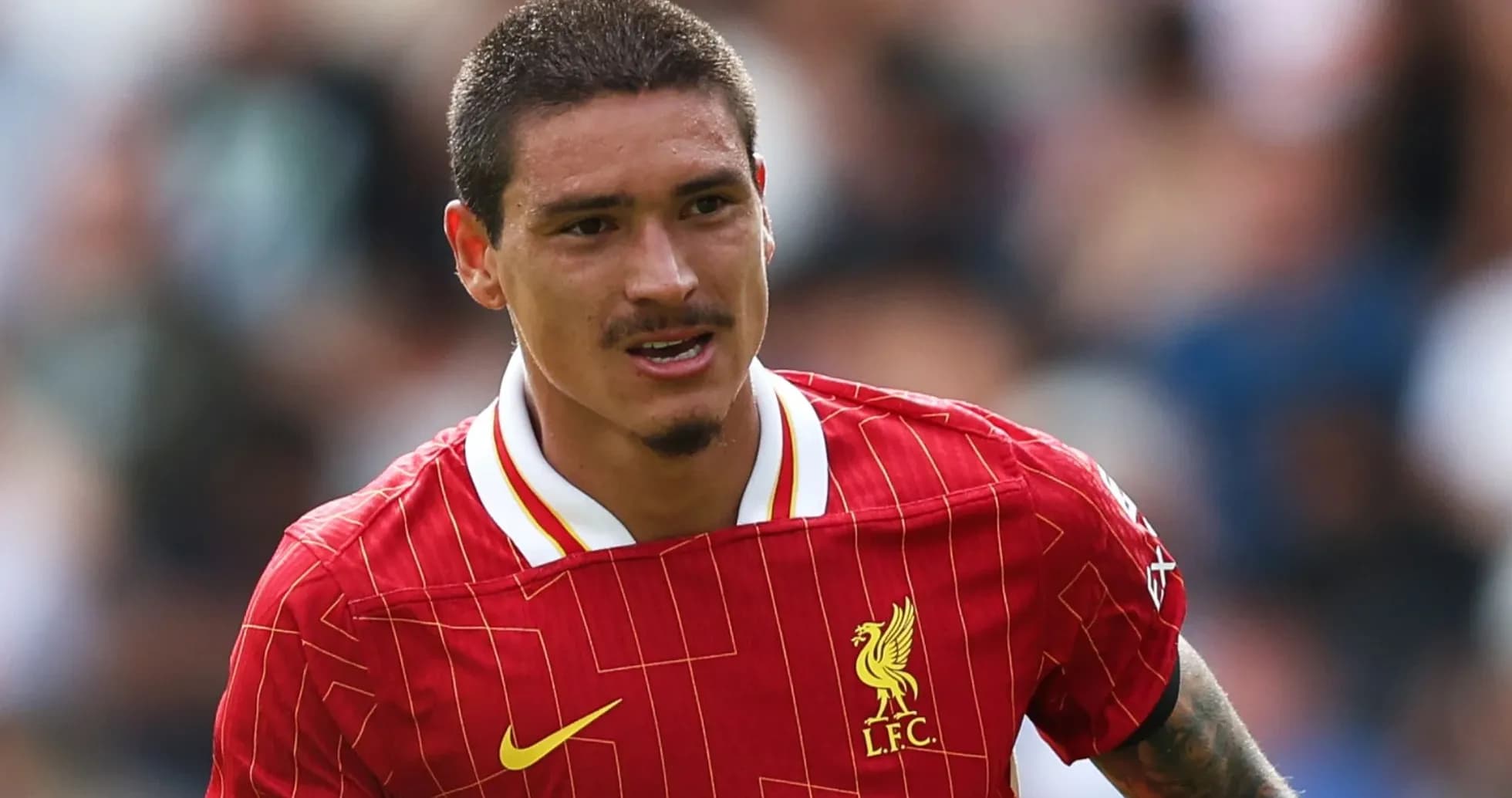 Player in Liverpool jersey running during match Player in Liverpool jersey running during match