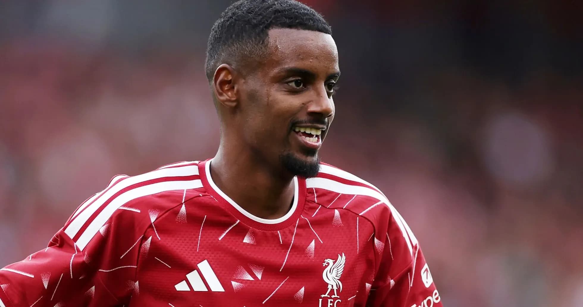 Player smiling while wearing Liverpool FC training kit Player smiling while wearing Liverpool FC training kit
