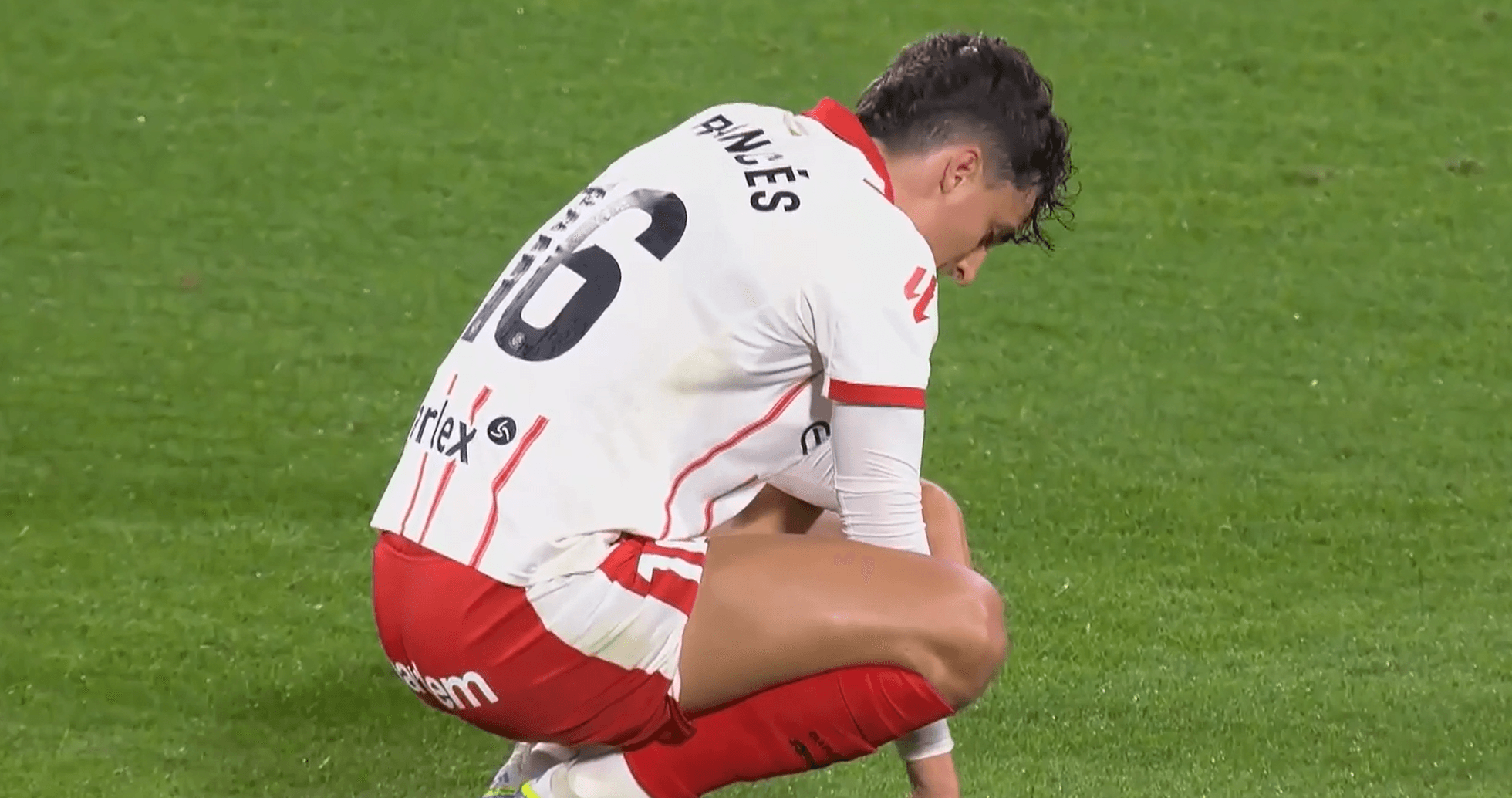 Player crouching on the pitch during match Player crouching on the pitch during match
