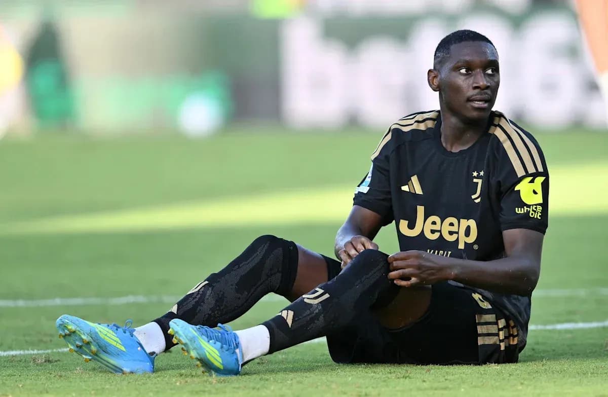 Juventus player sitting on field during match Juventus player sitting on field during match