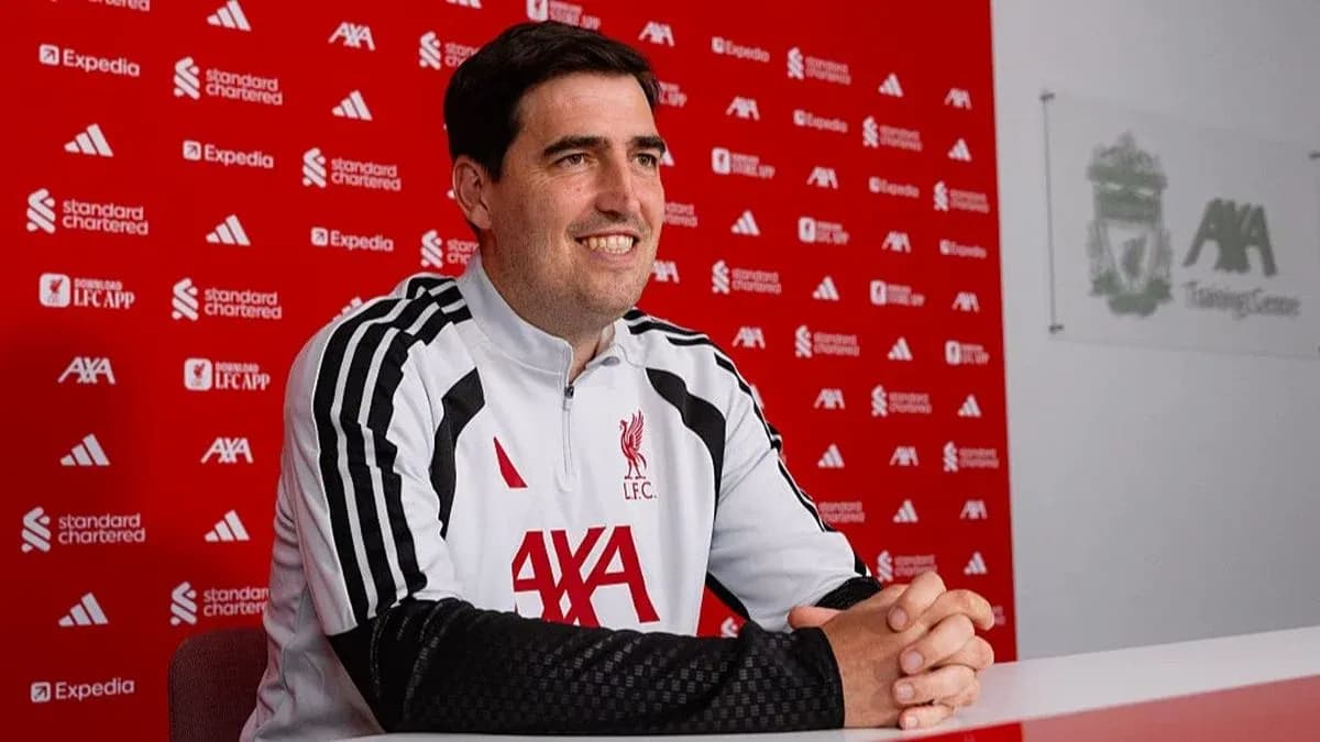 Coach seated at press conference table in training center Coach seated at press conference table in training center