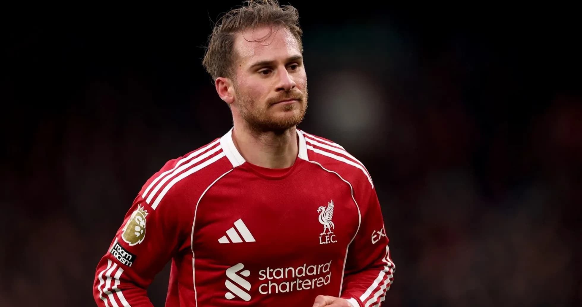 Player in Liverpool FC jersey on the field Player in Liverpool FC jersey on the field