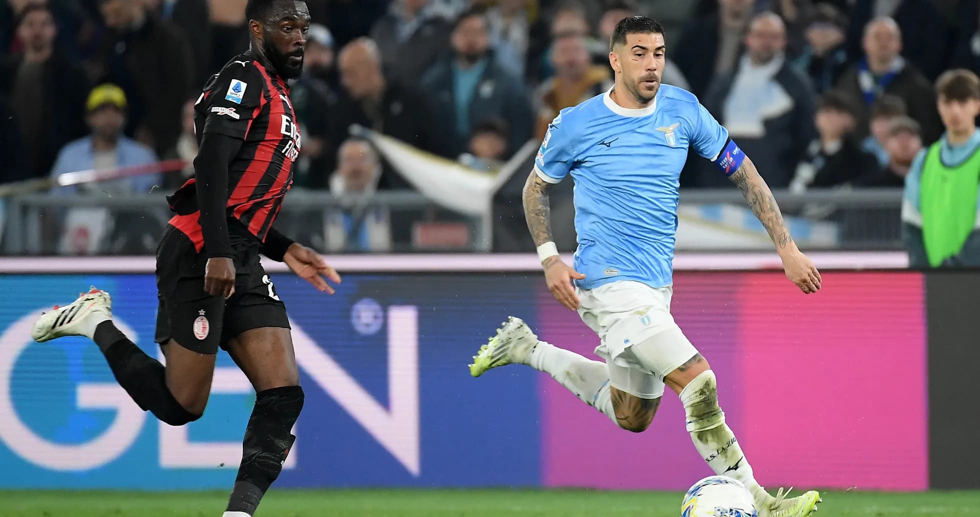 Lazio player dribbling past AC Milan defender Lazio player dribbling past AC Milan defender
