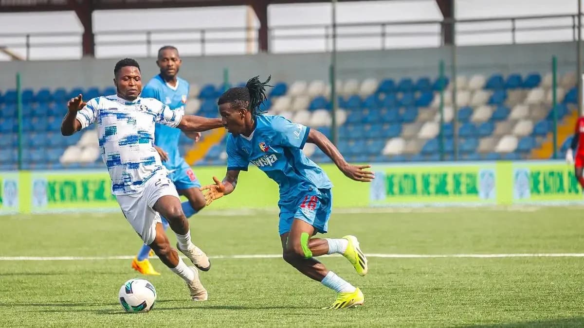 Warri Wolves player dribbling past Shooting Stars opponent Warri Wolves player dribbling past Shooting Stars opponent