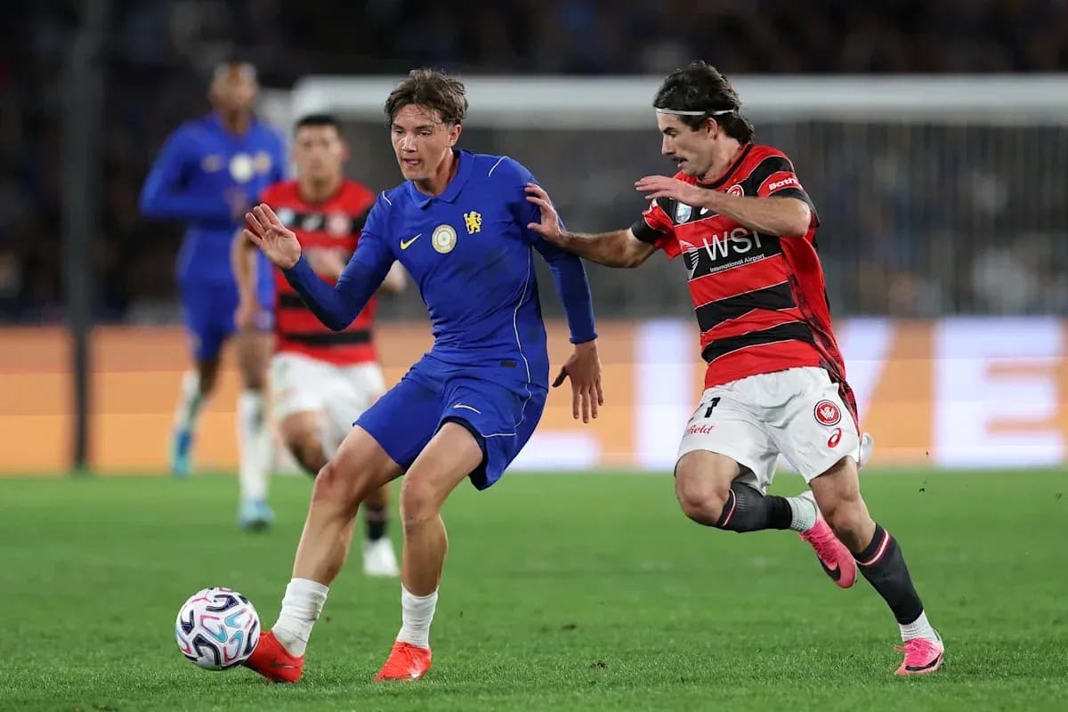 Player in blue evading opponent in red during match Player in blue evading opponent in red during match