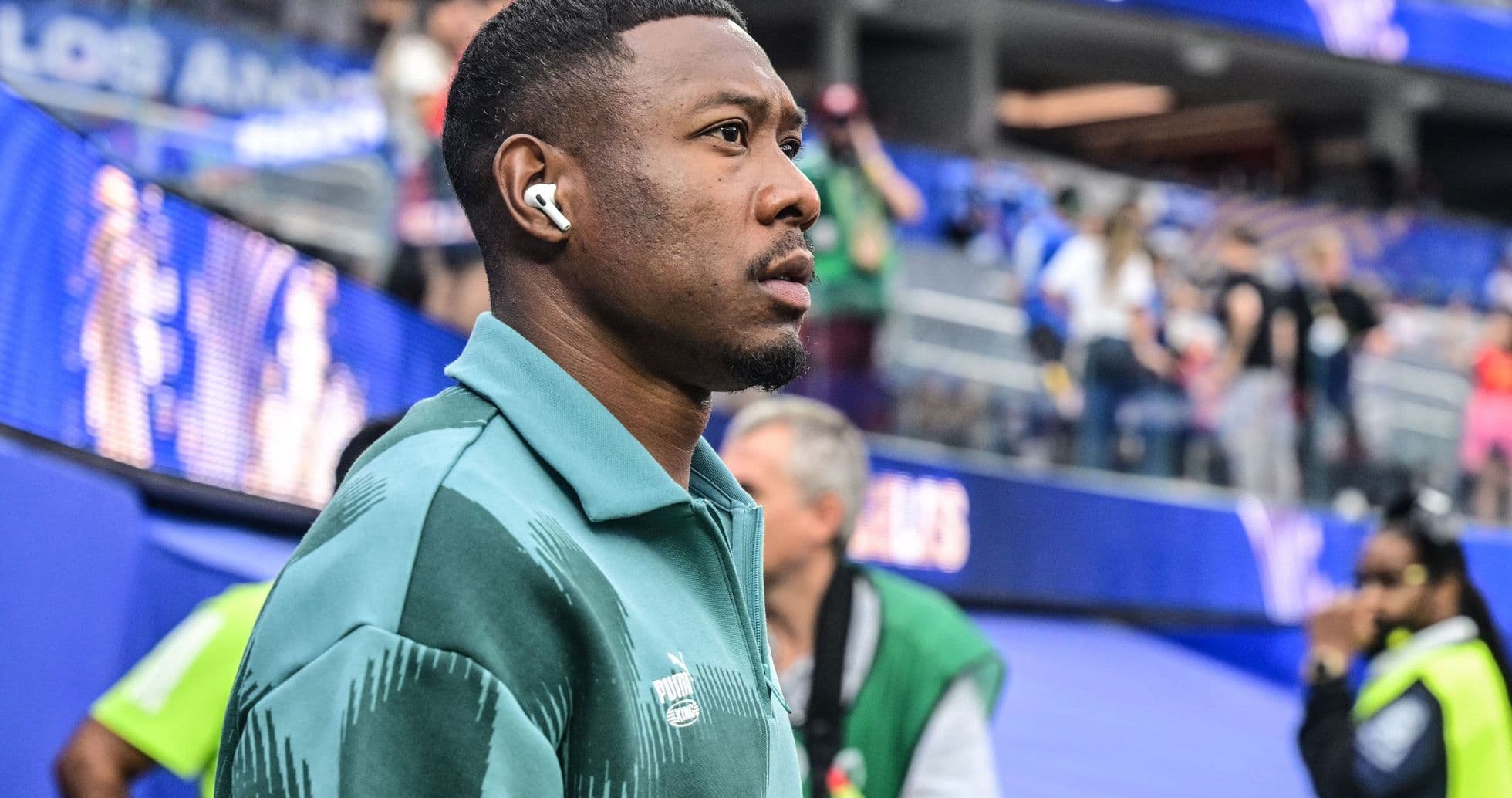 Player walking in stadium wearing headphones Player walking in stadium wearing headphones