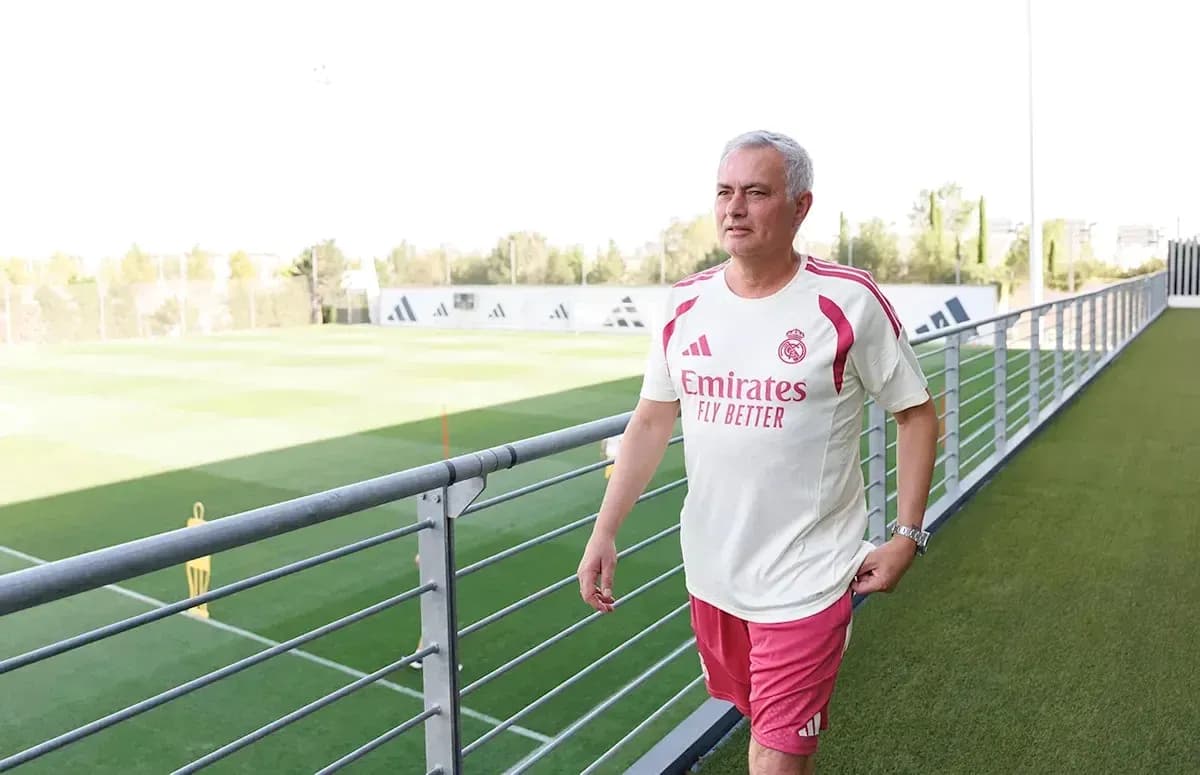 Manager walking on training pitch at facility Manager walking on training pitch at facility