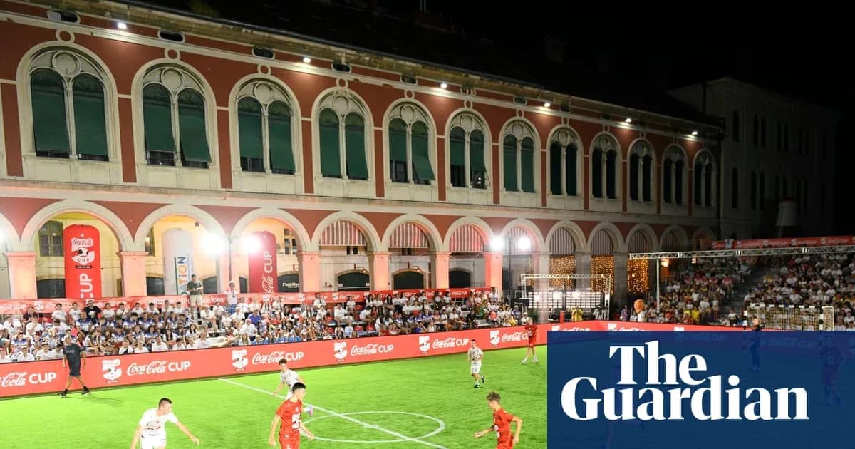 Players competing in a night football match event Players competing in a night football match event