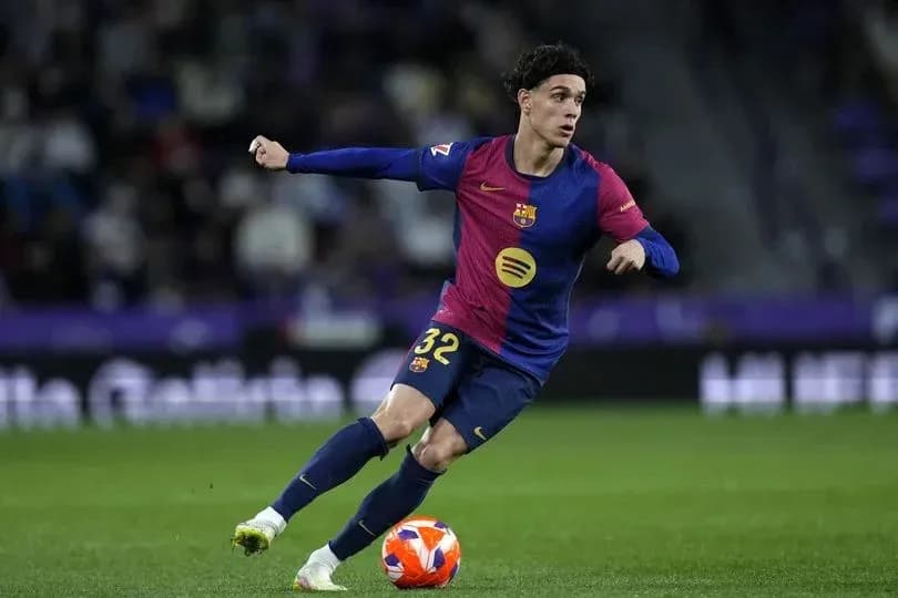 Barcelona player dribbling the ball on the pitch Barcelona player dribbling the ball on the pitch