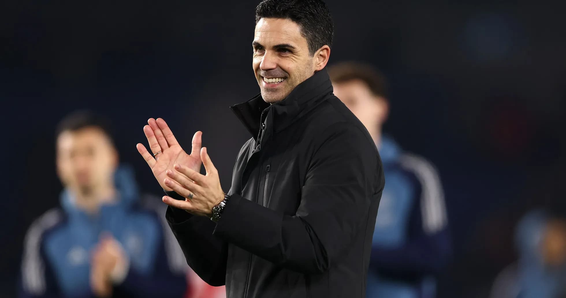 Coach clapping during team celebration on pitch Coach clapping during team celebration on pitch