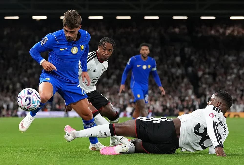 Chelsea player dribbling past Fulham defenders Chelsea player dribbling past Fulham defenders