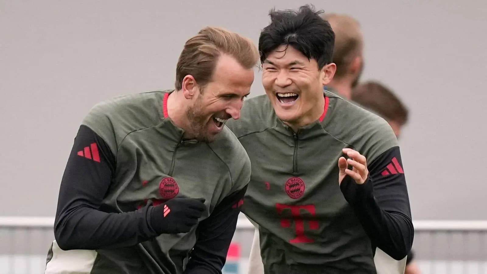 Two players laughing during Bayern Munich training session Two players laughing during Bayern Munich training session