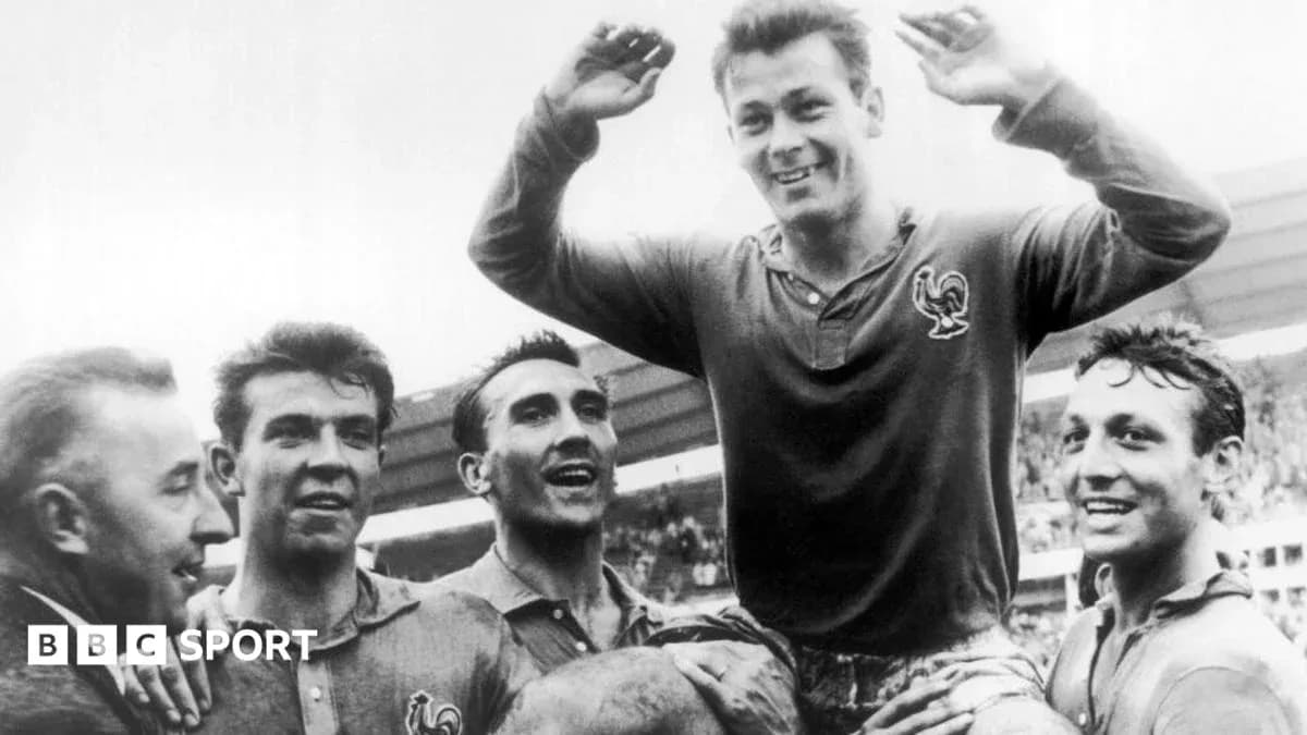 Players celebrating a victory, one lifted on shoulders Players celebrating a victory, one lifted on shoulders