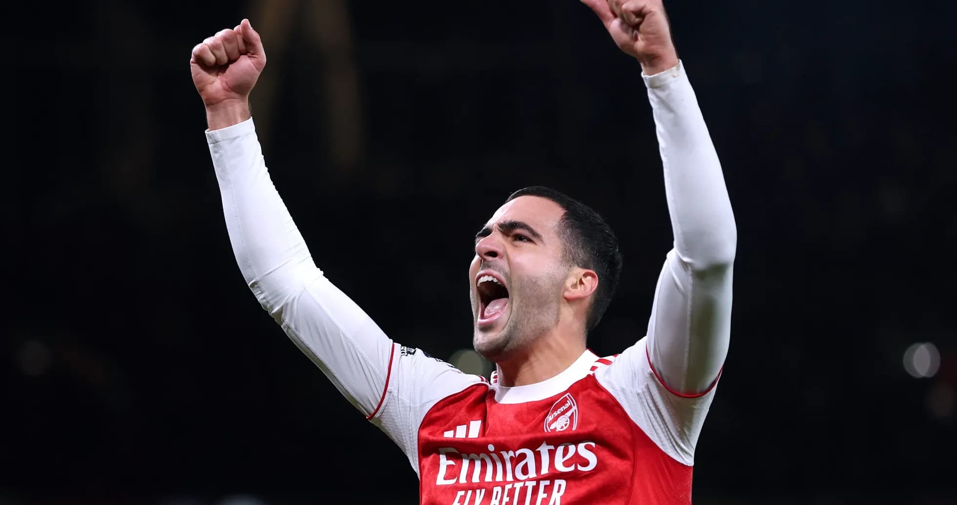 Player celebrating with raised arms in Arsenal jersey Player celebrating with raised arms in Arsenal jersey