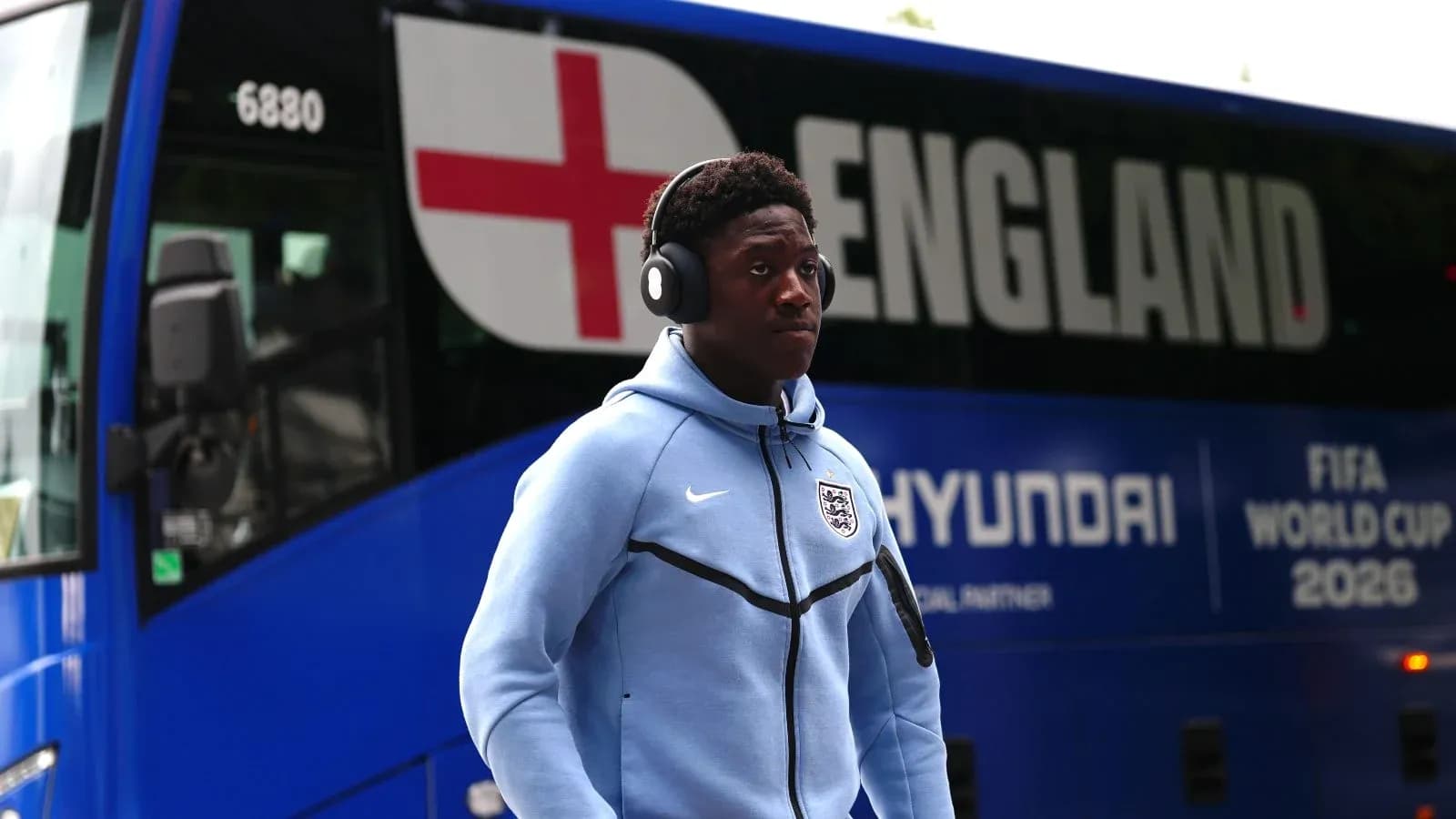 Player wearing headphones near England team bus Player wearing headphones near England team bus
