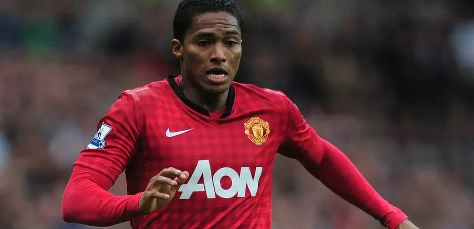 Player in red Manchester United kit running on field Player in red Manchester United kit running on field