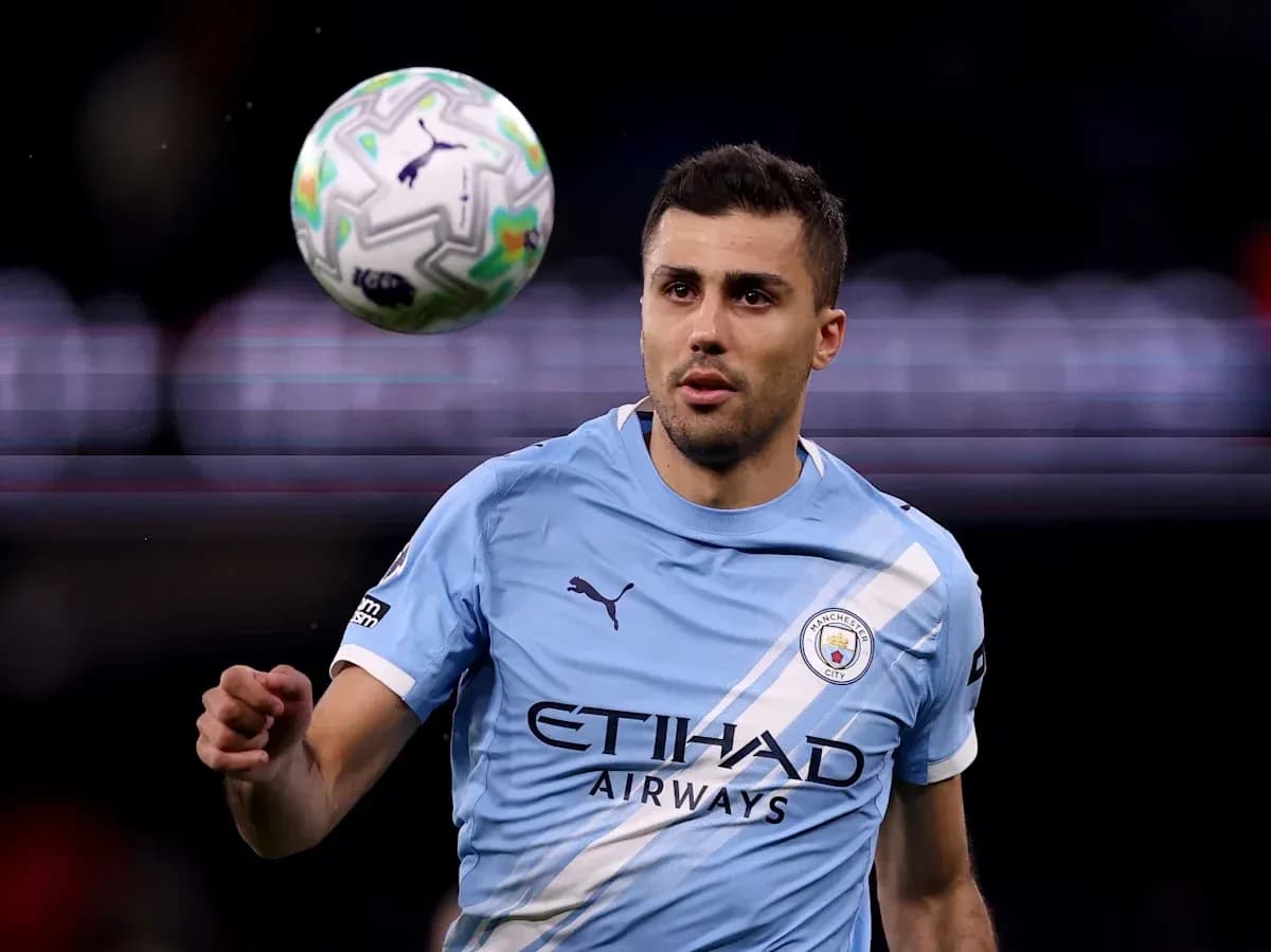 Player in light blue jersey controlling a football Player in light blue jersey controlling a football