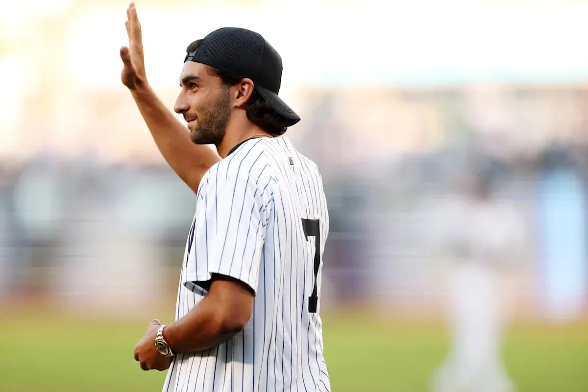 Man in baseball jersey waving at crowd Man in baseball jersey waving at crowd