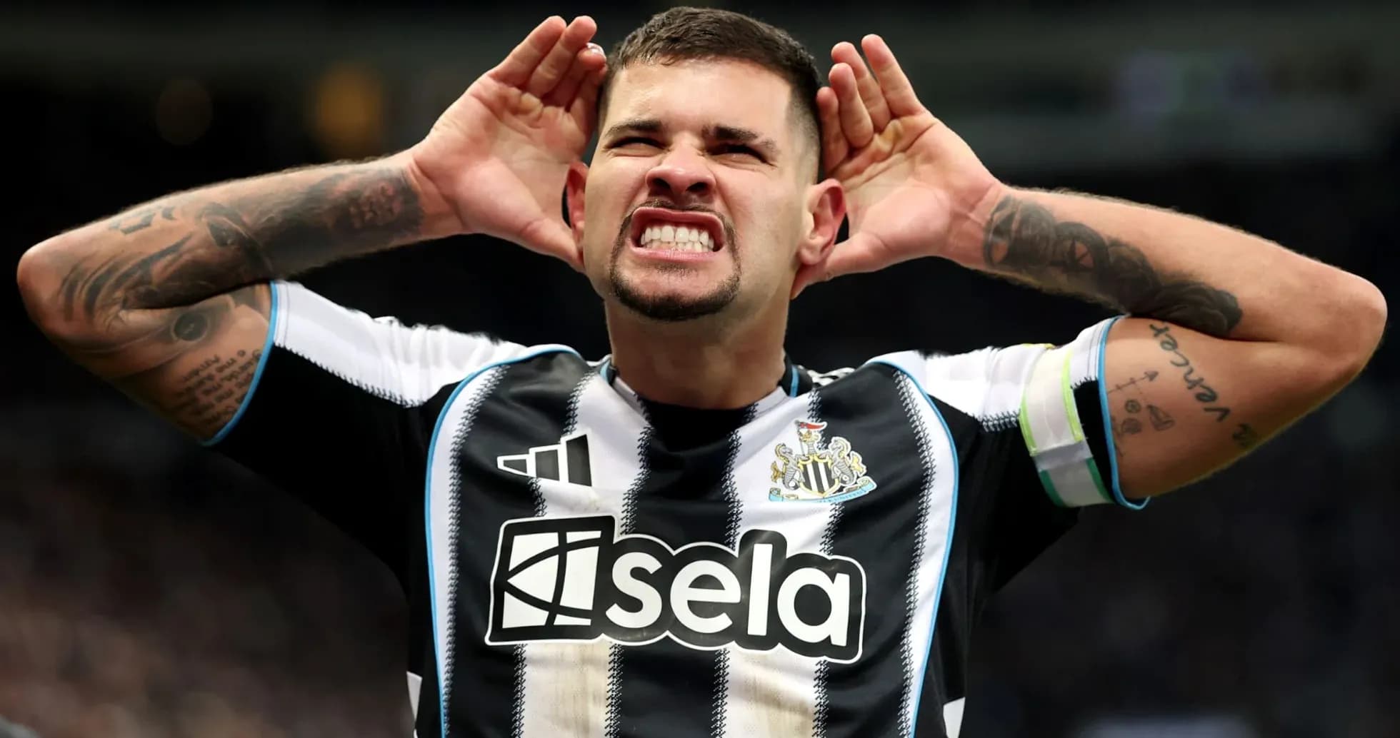 Player celebrating with hands on ears during match Player celebrating with hands on ears during match