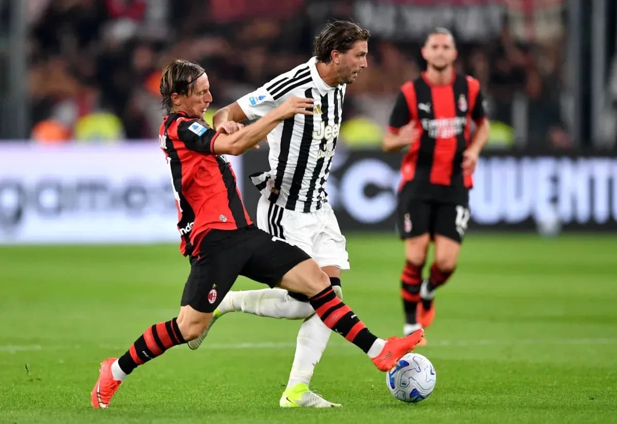 AC Milan player tackling Juventus player during match AC Milan player tackling Juventus player during match