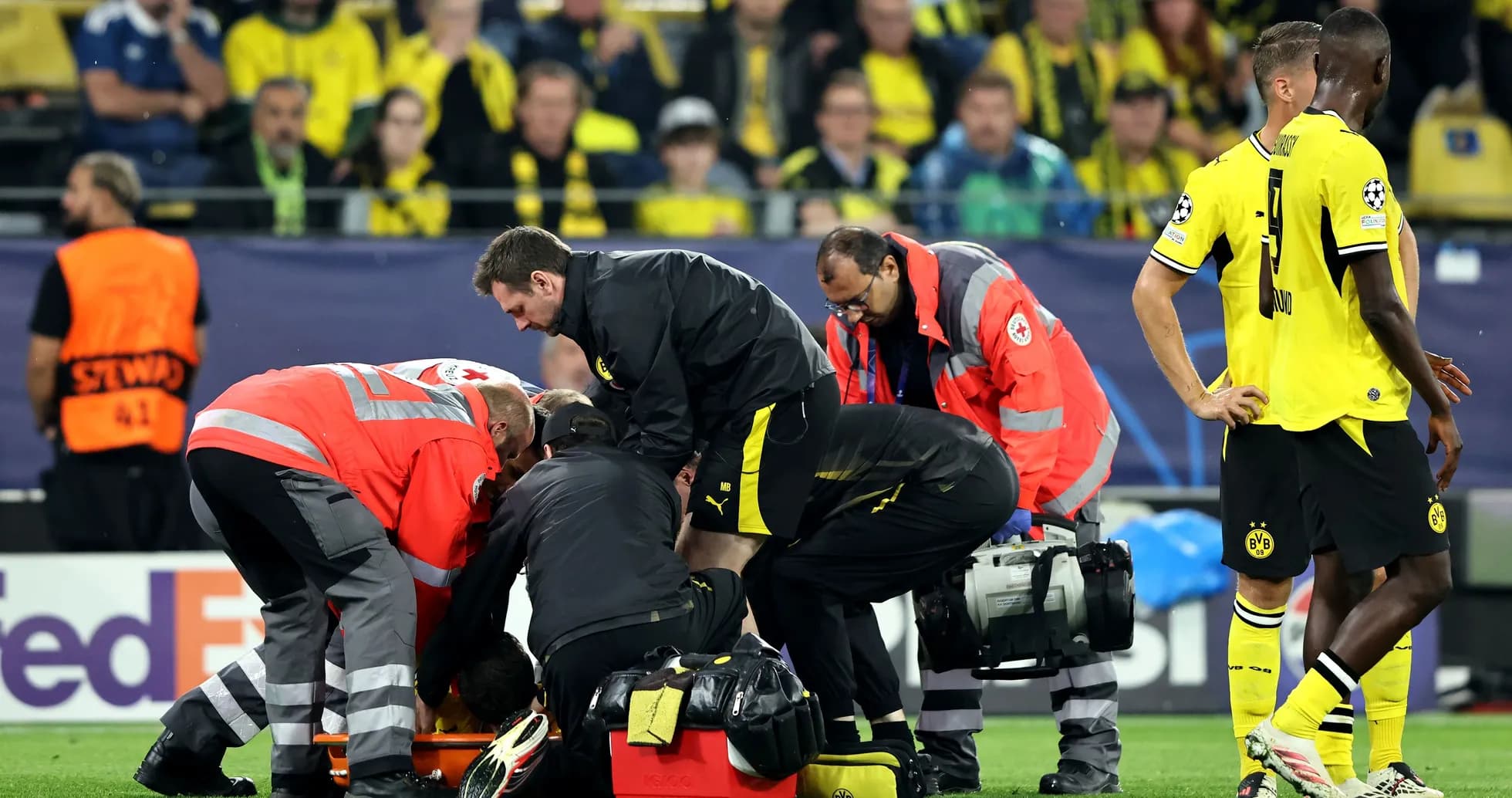 Medical staff attending to injured player on field Medical staff attending to injured player on field