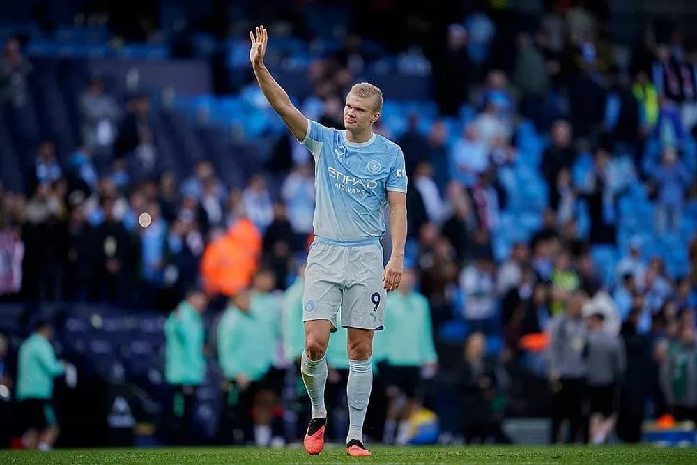 Player waving to fans at Manchester City match Player waving to fans at Manchester City match