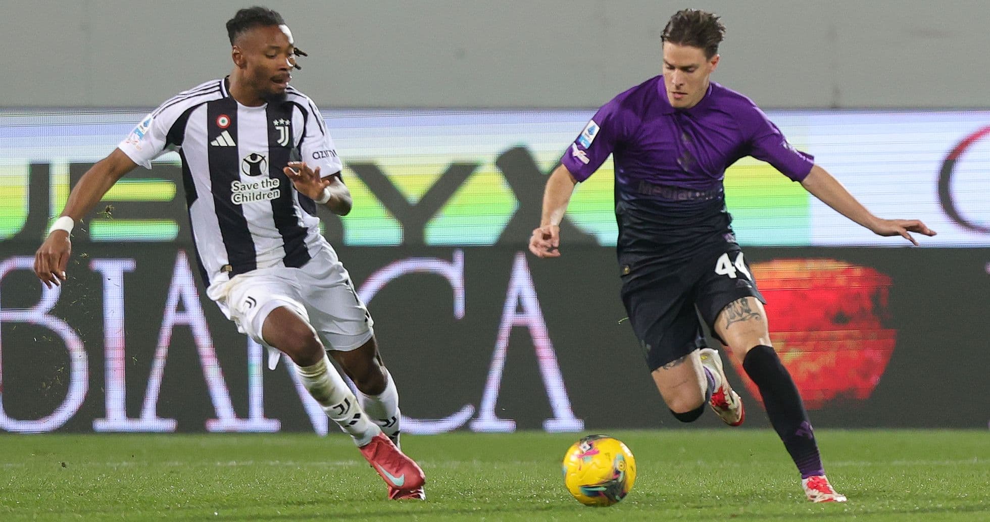 Juventus player tackling Fiorentina opponent Juventus player tackling Fiorentina opponent