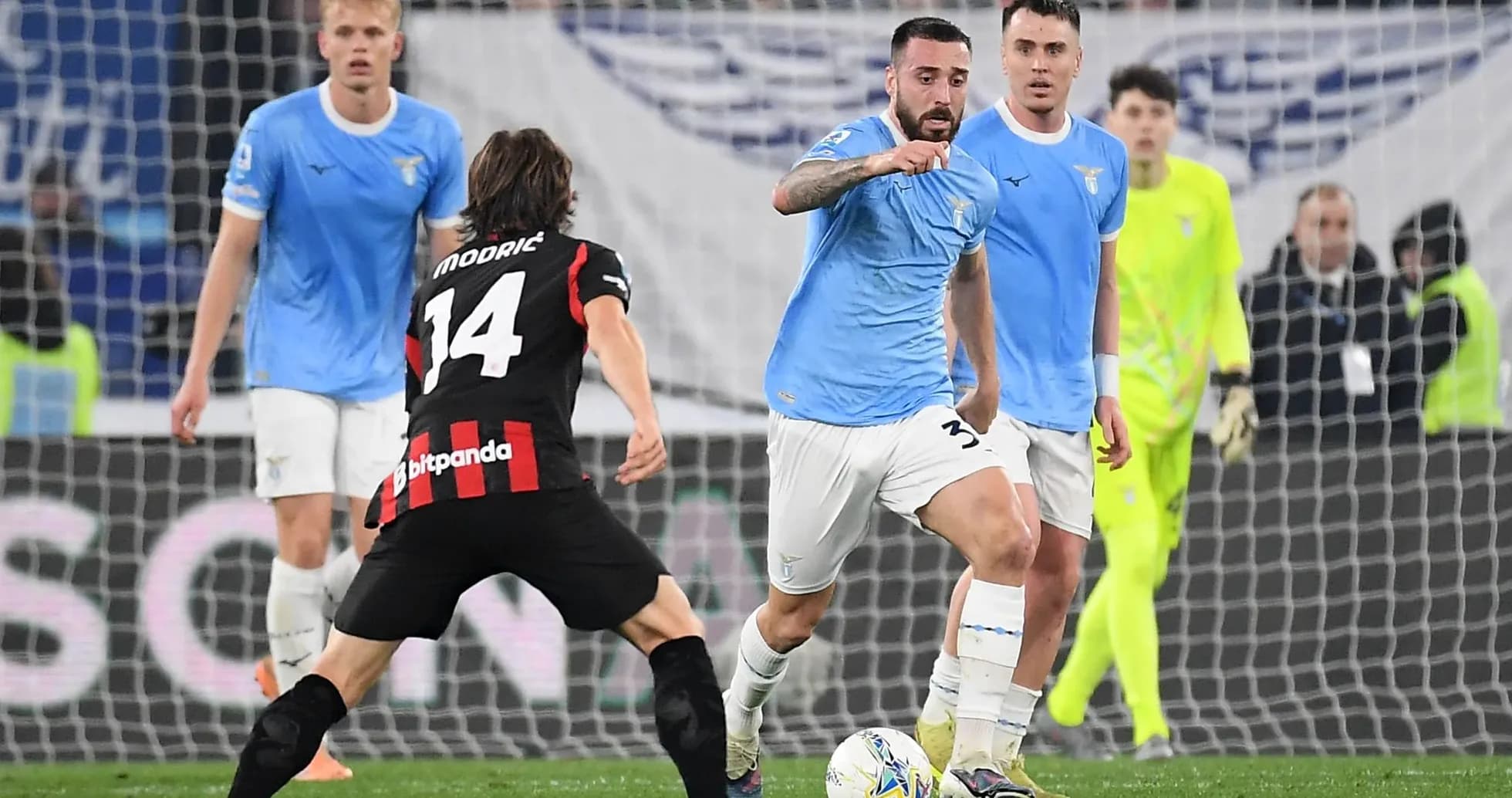 Lazio player dribbling against AC Milan opponent Lazio player dribbling against AC Milan opponent
