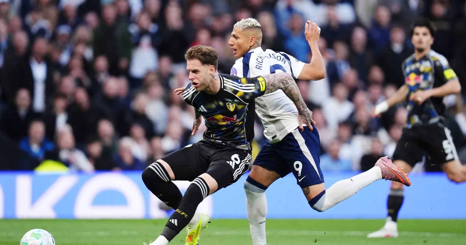 Player tackles opponent during Tottenham vs Leeds match Player tackles opponent during Tottenham vs Leeds match