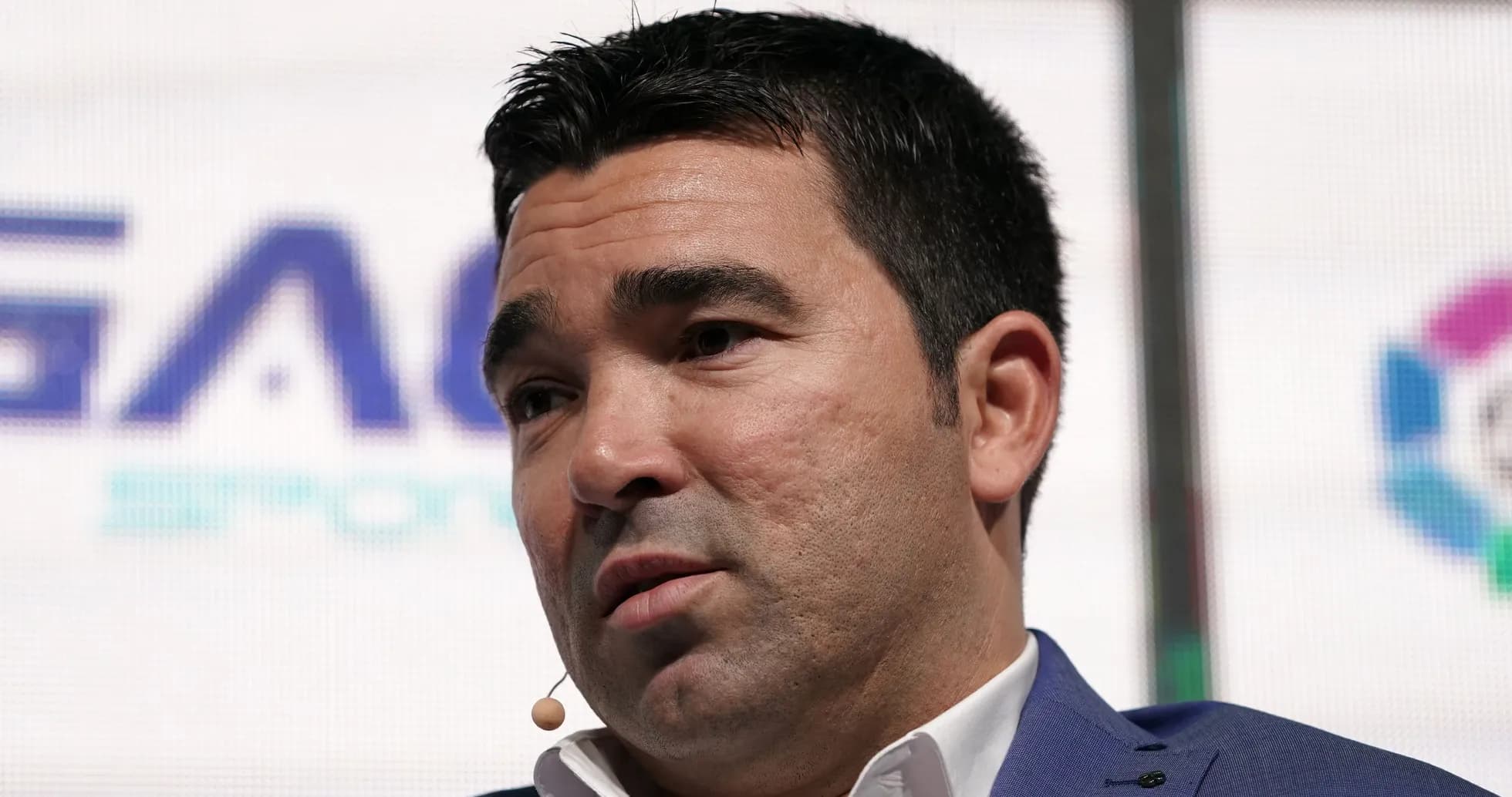 Man speaking at a conference with a microphone Man speaking at a conference with a microphone