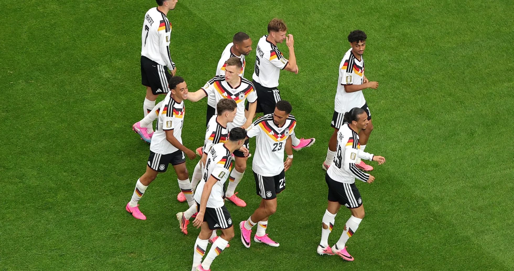 Germany team celebrating on the pitch Germany team celebrating on the pitch
