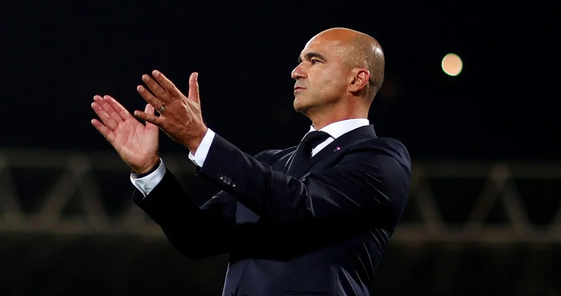 Manager applauding during a match from the sidelines Manager applauding during a match from the sidelines
