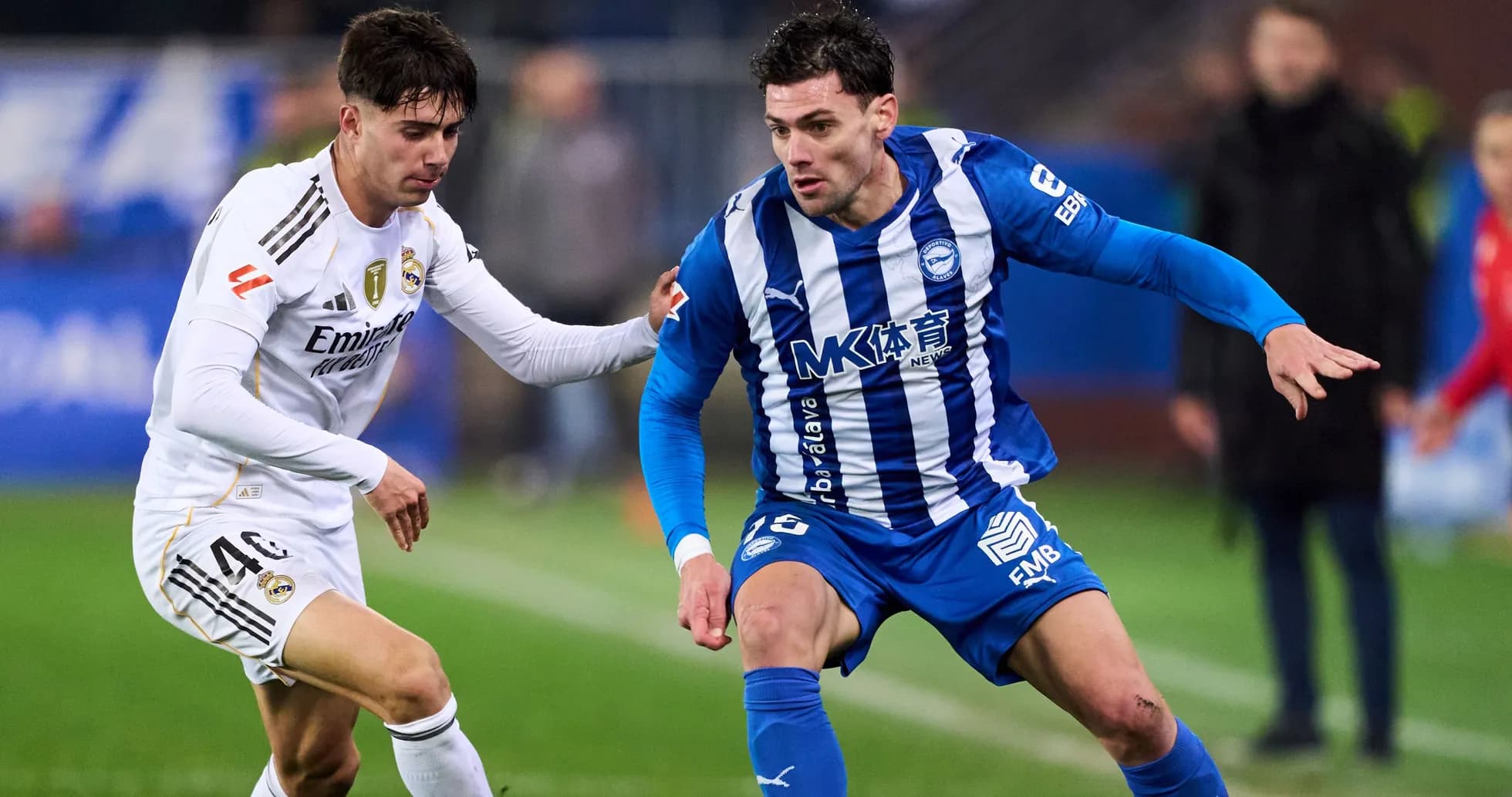 Two football players competing for possession of the ball Two football players competing for possession of the ball