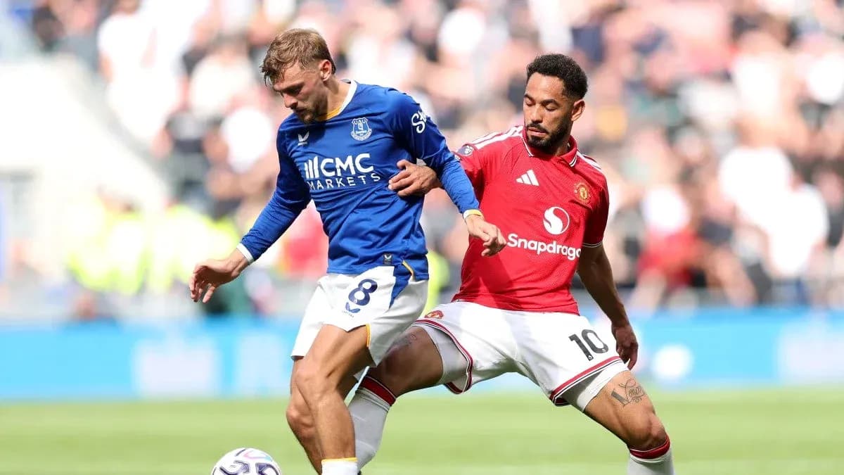 Everton and Manchester United players competing for the ball Everton and Manchester United players competing for the ball