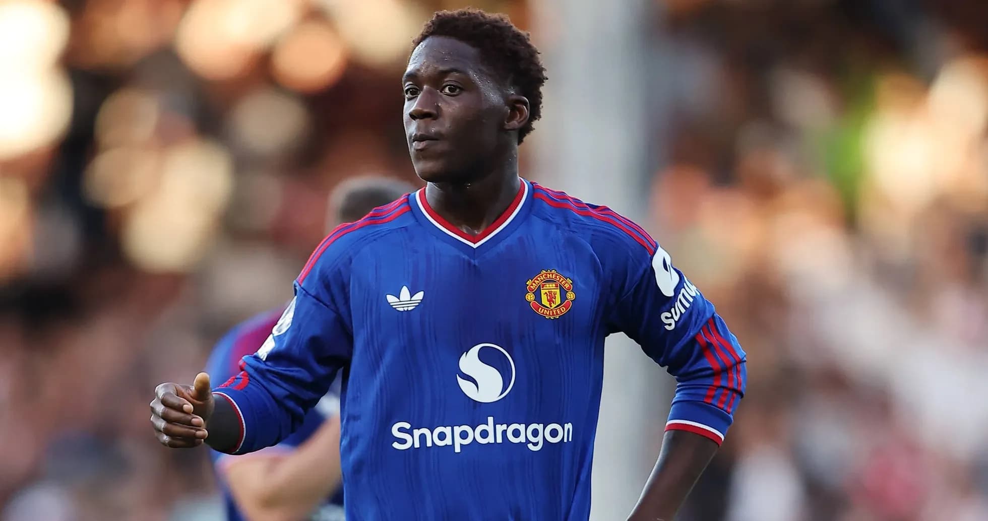 Player in blue Manchester United kit on field Player in blue Manchester United kit on field