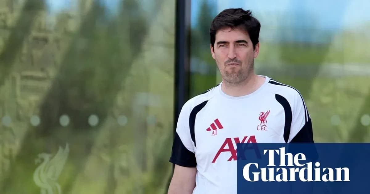 Man in Liverpool FC training shirt walking outside Man in Liverpool FC training shirt walking outside